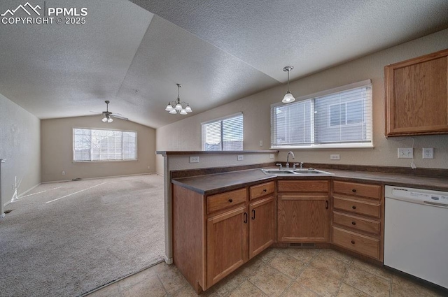 kitchen with lofted ceiling, sink, decorative light fixtures, white dishwasher, and light colored carpet