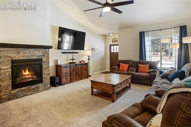 carpeted living room featuring ceiling fan, a stone fireplace, and vaulted ceiling