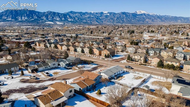 snowy aerial view featuring a mountain view