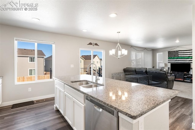 kitchen with sink, dishwasher, white cabinets, a center island with sink, and decorative light fixtures