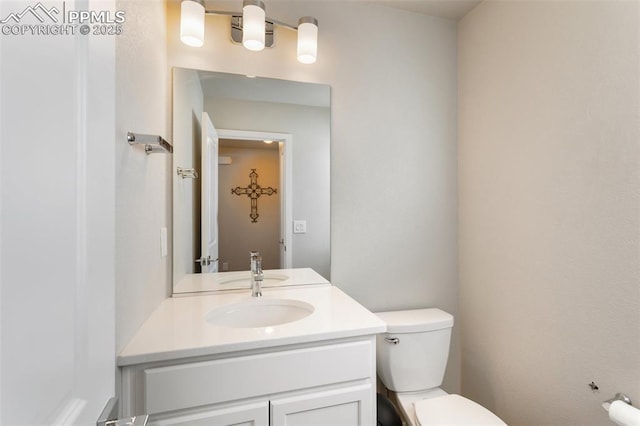 bathroom featuring vanity and toilet