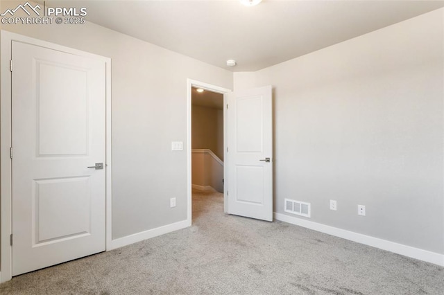 unfurnished bedroom with light colored carpet