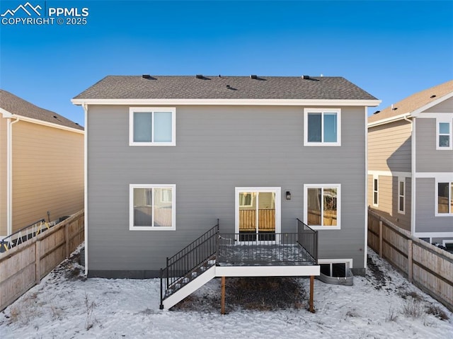 snow covered property featuring a wooden deck