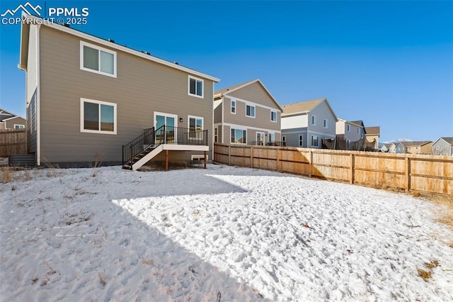 snow covered property with a wooden deck