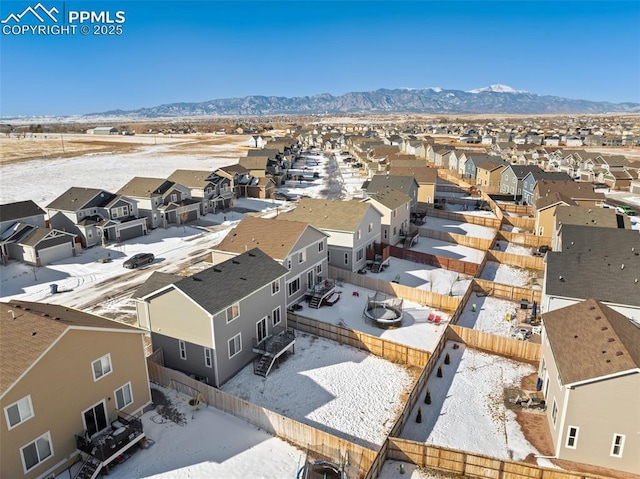 snowy aerial view with a mountain view