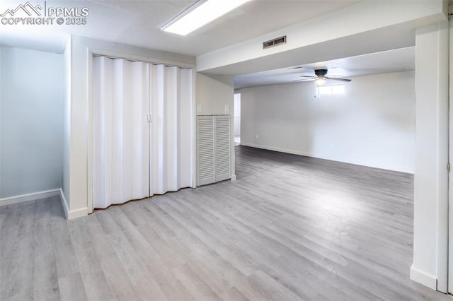 empty room with light hardwood / wood-style floors and ceiling fan