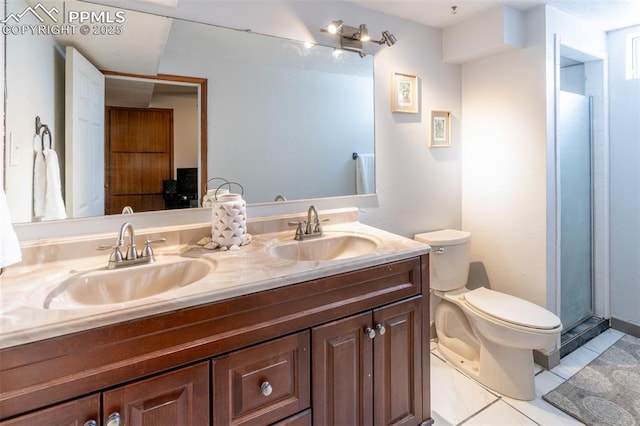 bathroom featuring a shower with door, vanity, and toilet