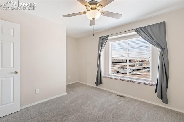 carpeted spare room with ceiling fan