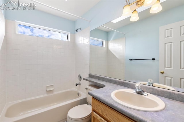 full bathroom with vanity, toilet, and tiled shower / bath