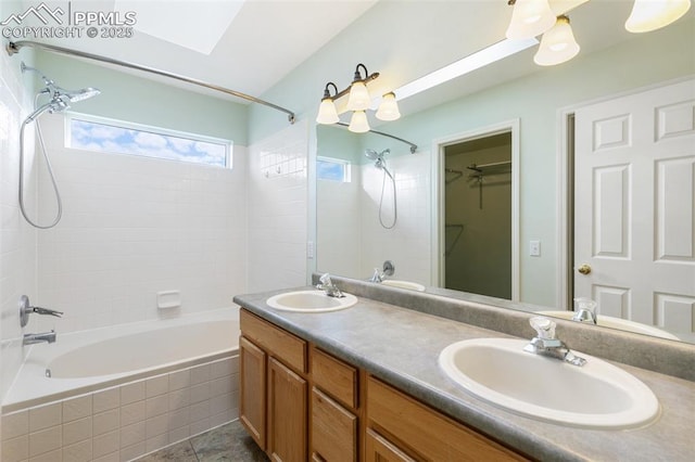 bathroom featuring tiled shower / bath combo, vanity, and tile patterned flooring