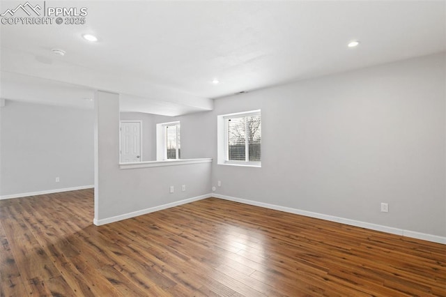 empty room with dark hardwood / wood-style flooring