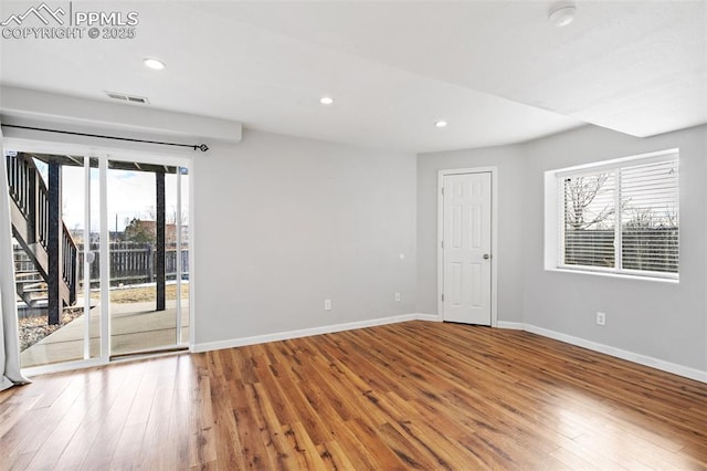 empty room with hardwood / wood-style floors