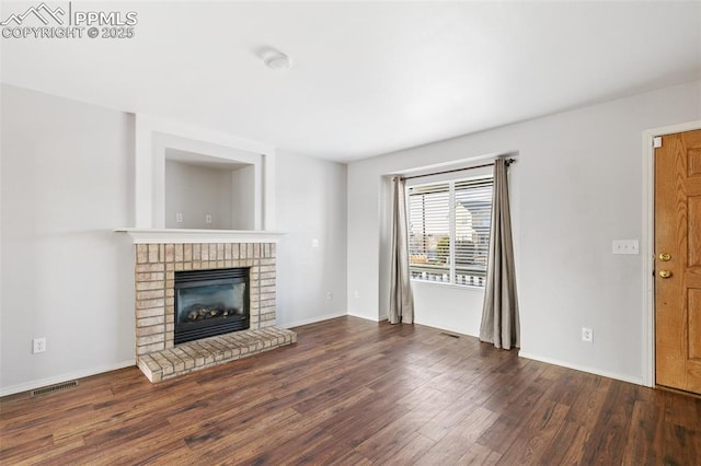 unfurnished living room with dark wood-type flooring and a fireplace