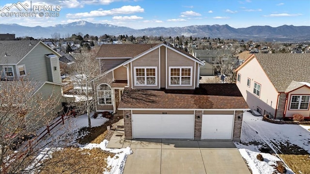 view of front facade featuring a mountain view and a garage