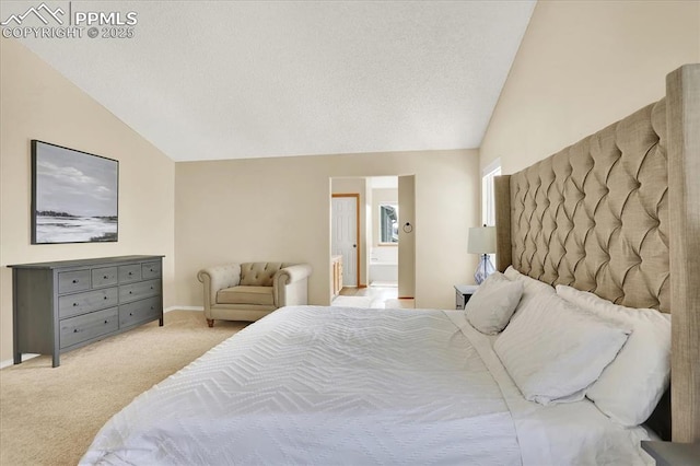 carpeted bedroom with connected bathroom, vaulted ceiling, and a textured ceiling