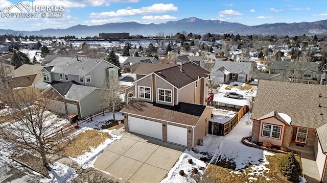 snowy aerial view with a mountain view