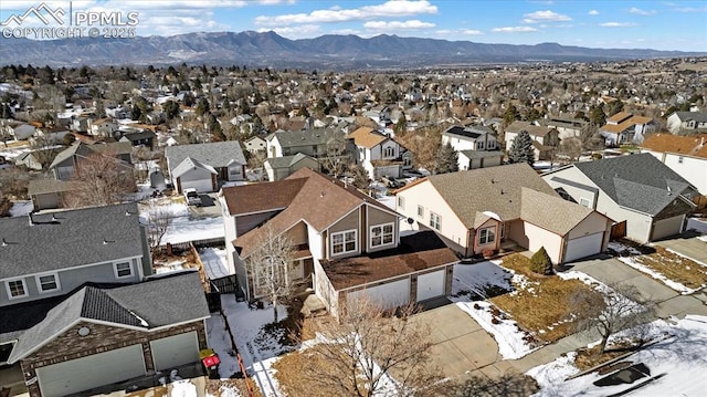 snowy aerial view with a mountain view