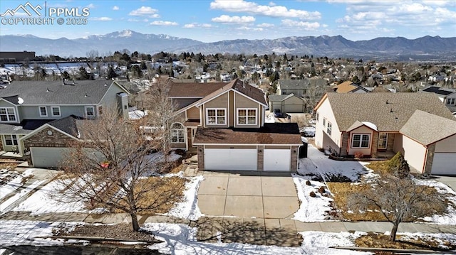 snowy aerial view featuring a mountain view