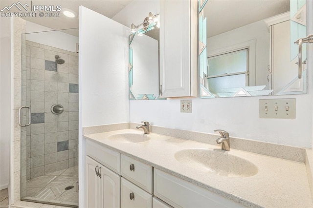 bathroom featuring a shower with door and vanity