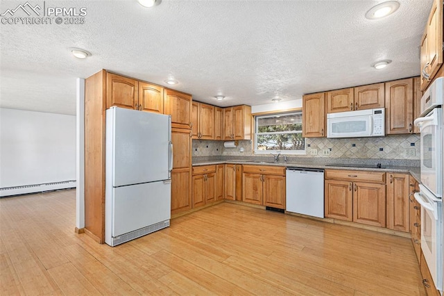 kitchen with white appliances, light hardwood / wood-style flooring, decorative backsplash, and baseboard heating