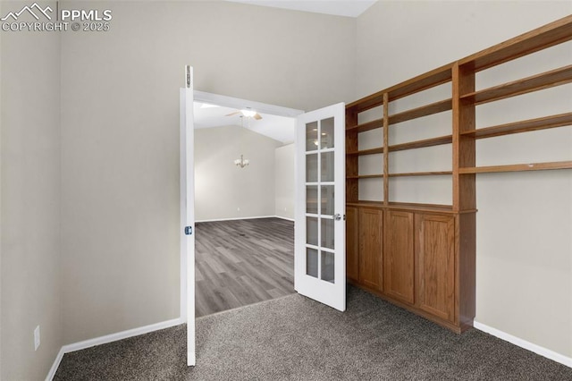 carpeted spare room featuring french doors and a chandelier