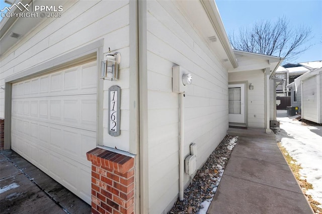 view of property exterior featuring a garage and central AC unit