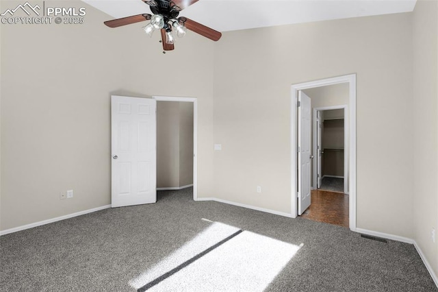 unfurnished bedroom featuring lofted ceiling and dark carpet