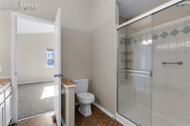 bathroom with vanity, an enclosed shower, and toilet