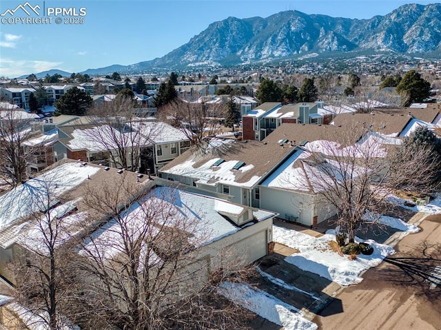 snowy aerial view with a mountain view