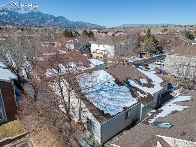 snowy aerial view with a mountain view