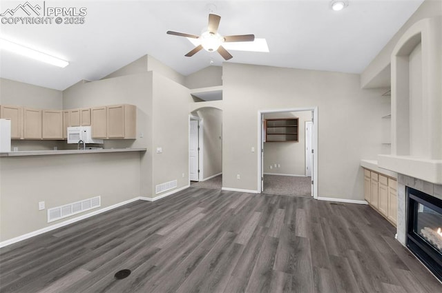 unfurnished living room with ceiling fan, high vaulted ceiling, dark wood-type flooring, and a fireplace