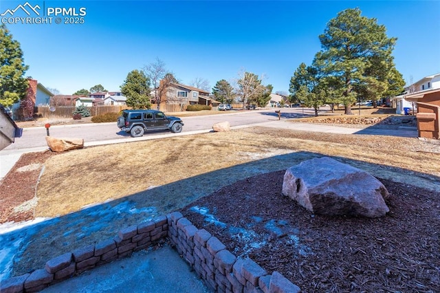 view of yard with fence and a residential view