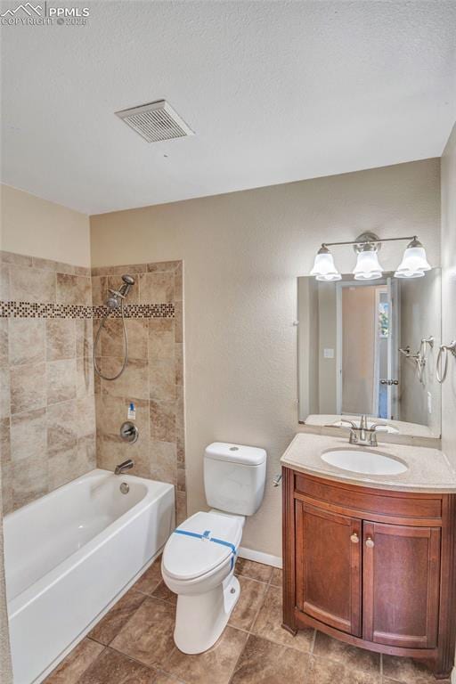 full bath featuring a textured ceiling, toilet, vanity, visible vents, and  shower combination