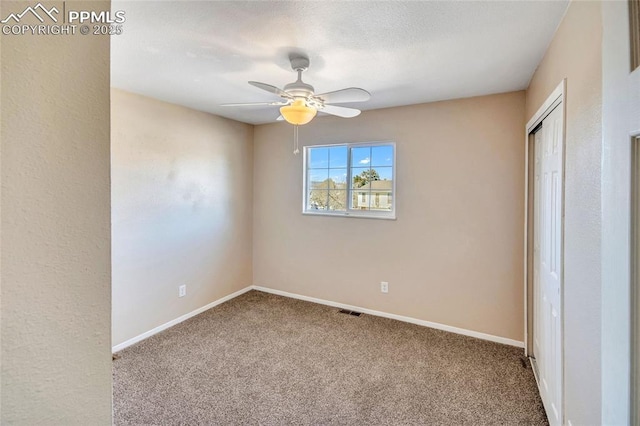 unfurnished bedroom featuring carpet, a closet, visible vents, and baseboards