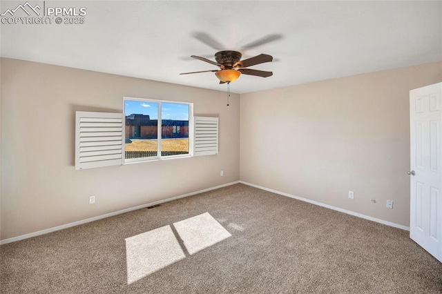 carpeted empty room with visible vents, ceiling fan, and baseboards