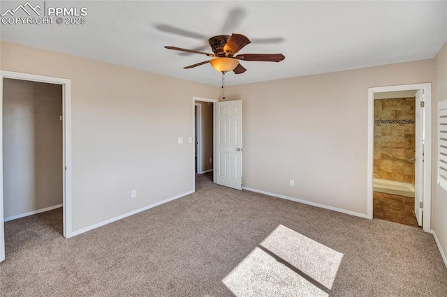 unfurnished bedroom featuring carpet flooring, ceiling fan, ensuite bath, and baseboards