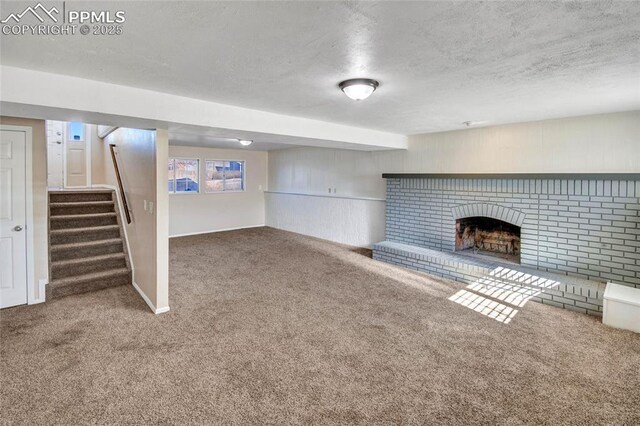 unfurnished living room with carpet, a fireplace, a textured ceiling, and stairs