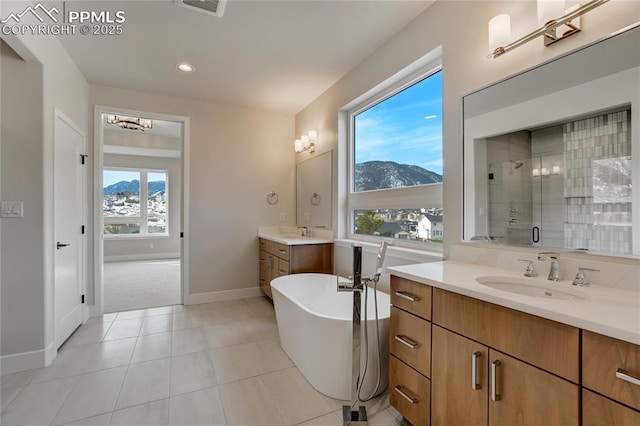 bathroom with vanity, plus walk in shower, a mountain view, and tile patterned flooring