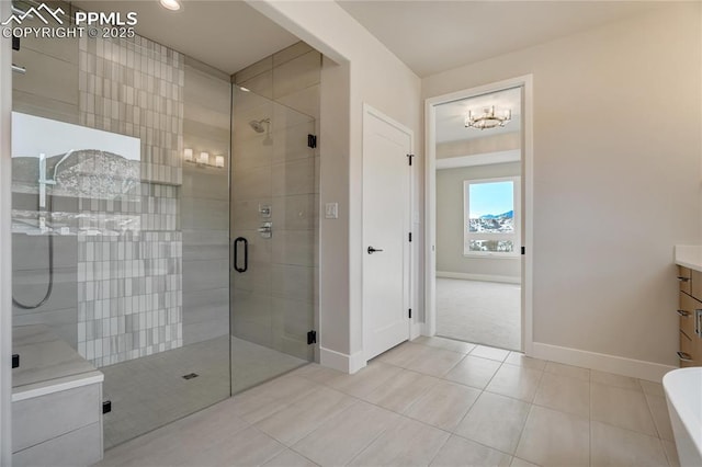 bathroom featuring vanity, tile patterned floors, and a shower with door