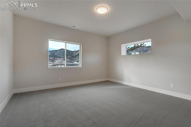 carpeted empty room with a mountain view