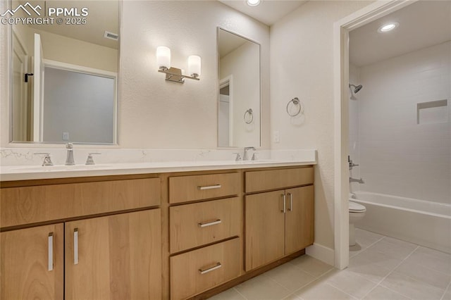 full bathroom with tile patterned flooring, vanity, tiled shower / bath combo, and toilet