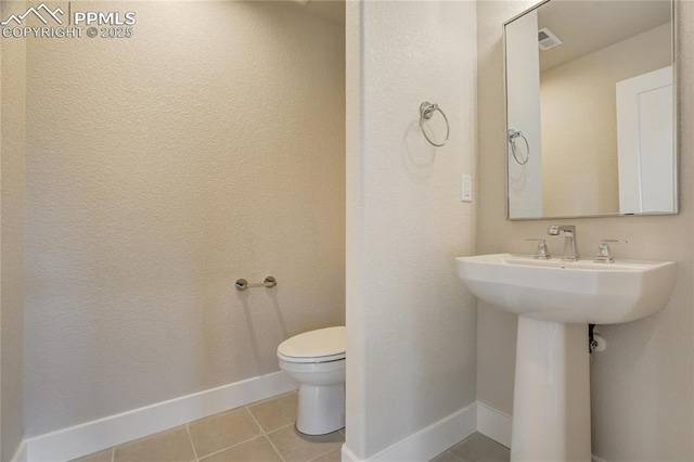 bathroom featuring tile patterned floors and toilet