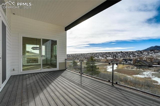 snow covered deck with a mountain view