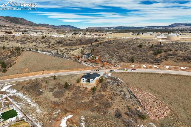 birds eye view of property featuring a mountain view