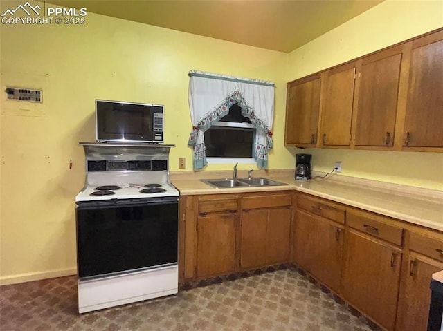 kitchen featuring white range with electric cooktop and sink