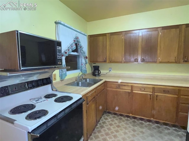 kitchen with electric range oven and sink