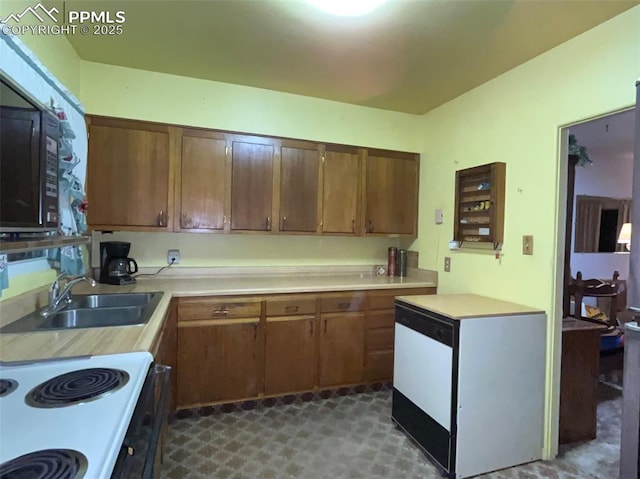 kitchen with sink, fridge, and white electric range oven