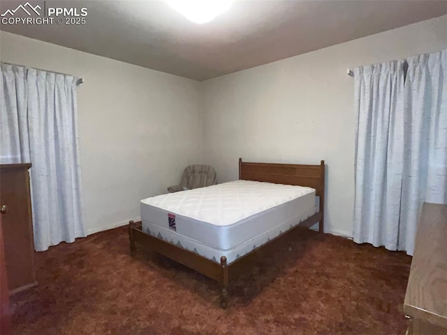 bedroom with dark carpet