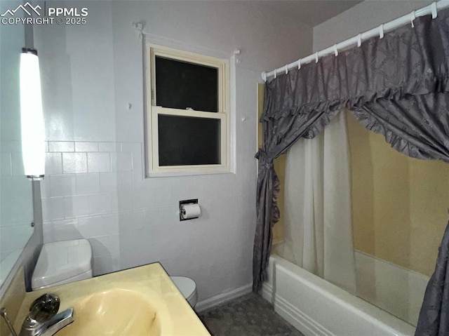 full bathroom with tile walls, sink, shower / bath combination with curtain, and toilet