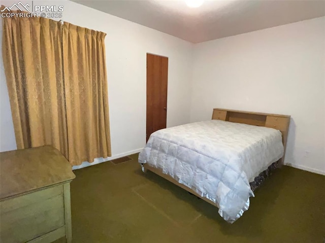 bedroom with dark carpet